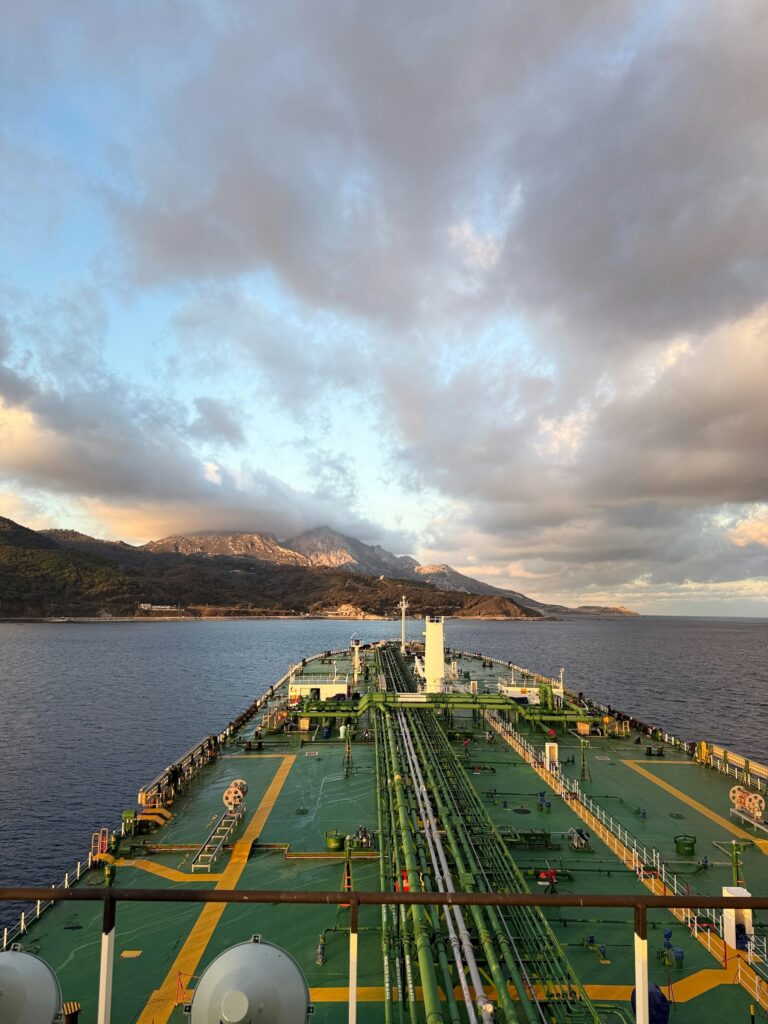 Tanker ship sailing under cloudy sky