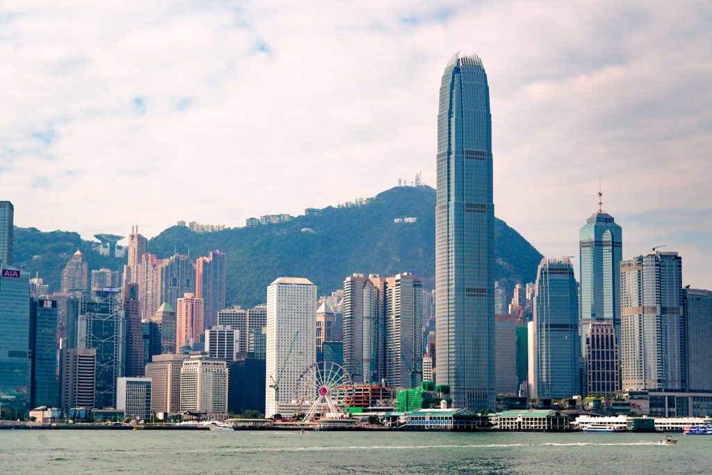 Night view of Hong Kong's illuminated financial district skyline with high-rise office towers along the harbour