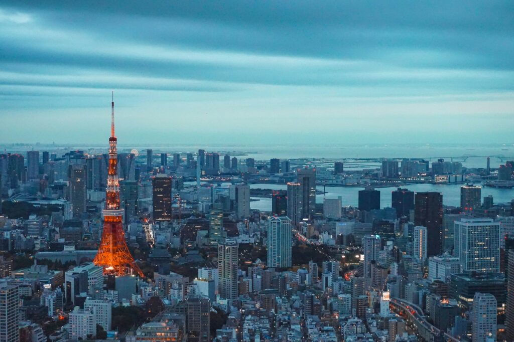 Tokyo Tower illuminated at dusk with the city skyline